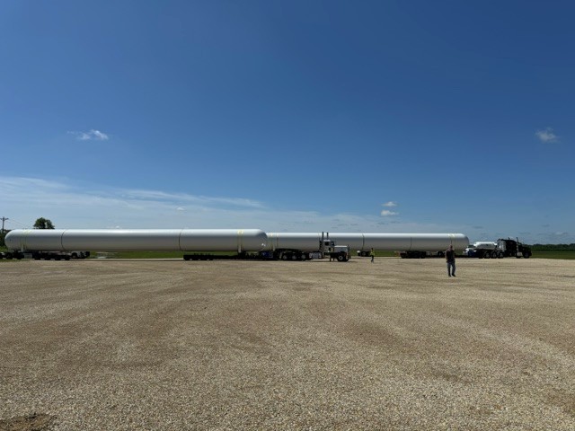 Storage tanks staged on transport trailers at the site
